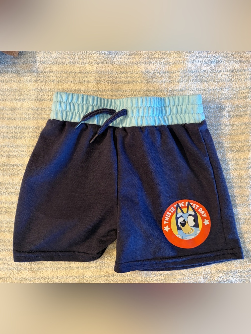 Navy Kids Shorts with Light Blue Elastic Waistband and Red Character Patch